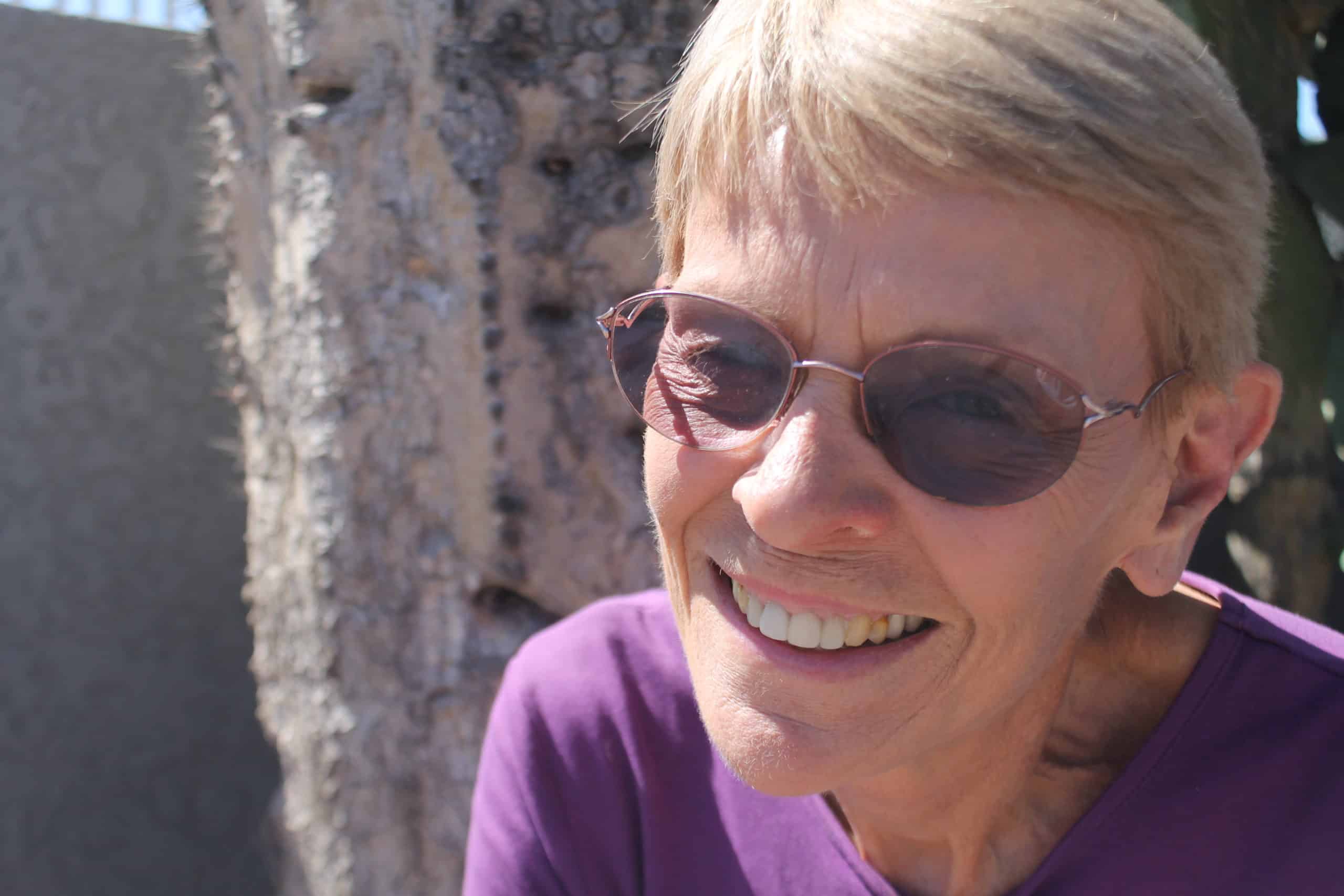 Volunteer management association volunteer smiling outdoors.