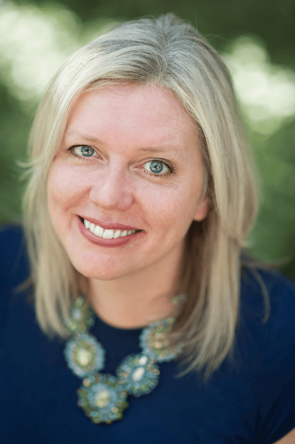 Engaged volunteer management professional with a warm smile and bright eyes.