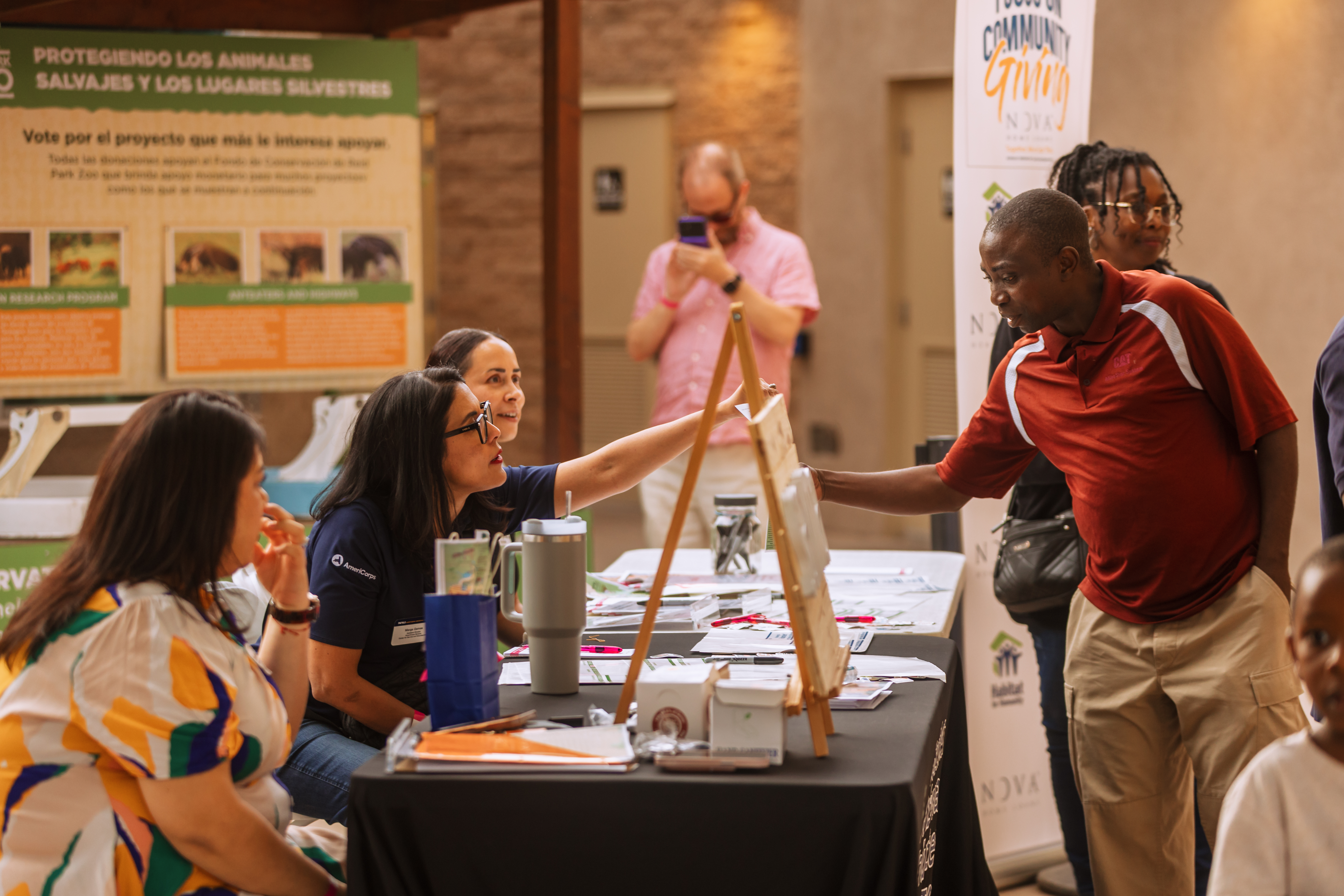 a volunteer booth with people discussing volunteer opportunities
